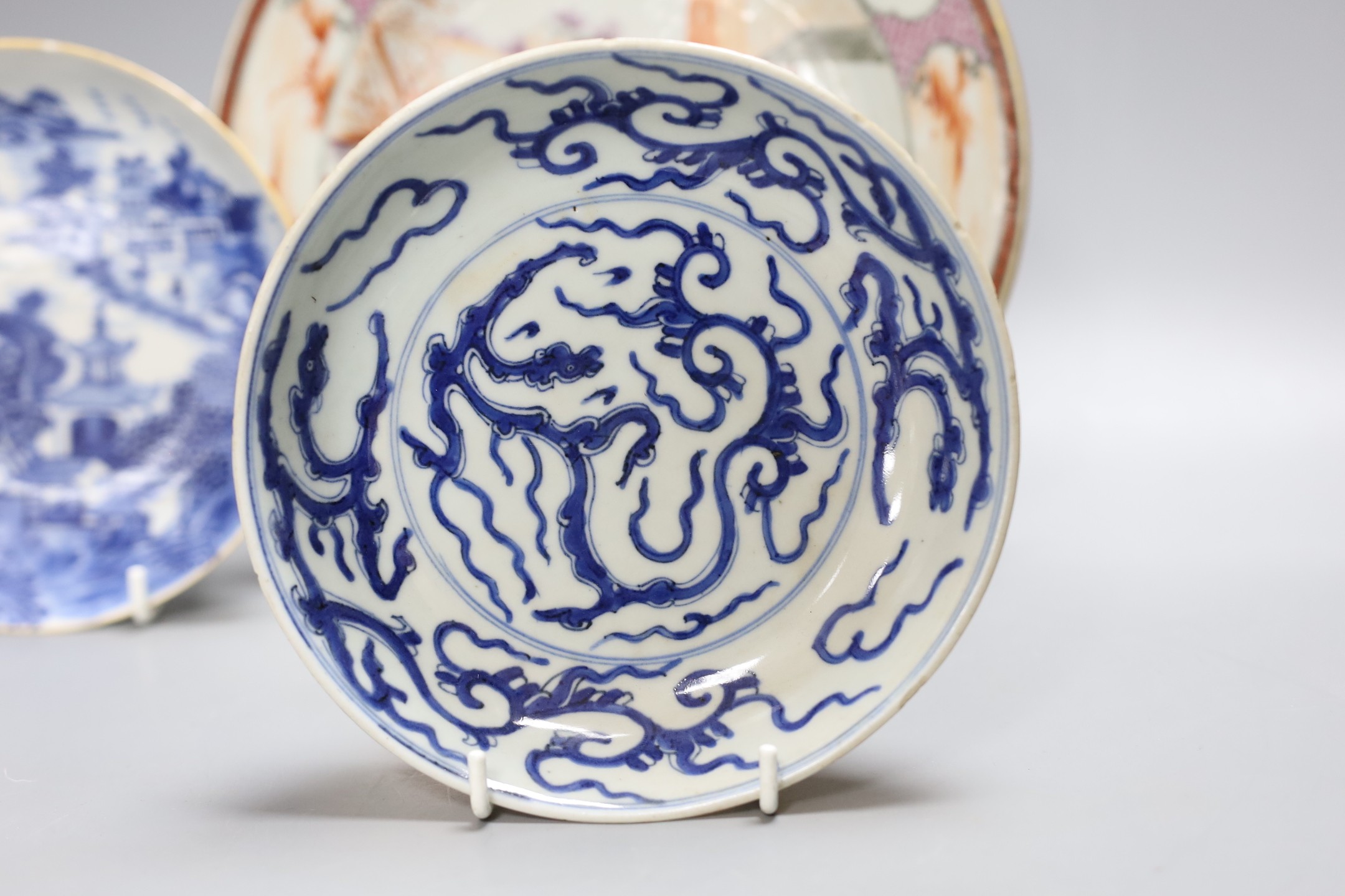 An 18th century Chinese export famille rose plate and two similar blue and white saucers, largest 23cm